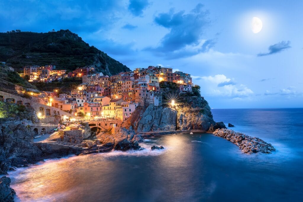 blue moon and manarola village at night cinque terre italy europe